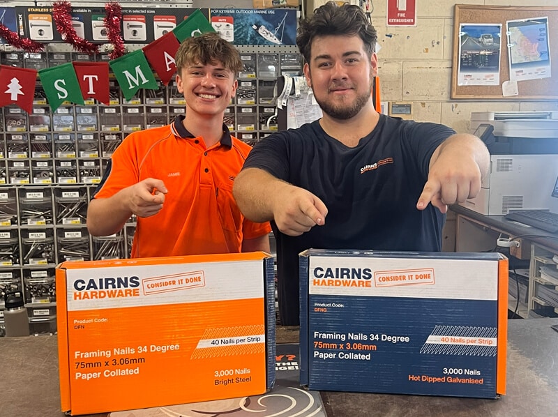 Two Cairns Hardware employees smiling and gesturing to products